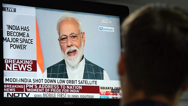 A man watches Indian Prime Minister Narendra Modi's address to the nation after the destruction of a low-orbiting satellite in a missile test that had put the country in the space "super league", Picture: Prakash Singh/AFP