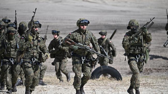 Troops from the Polish 18th Mechanised Division and the 82nd Airborne Division (USA) take part in tactical and fire training on April 8, 2022 in Nowa Deba, Poland. Picture: Jeff J Mitchell/Getty Images.