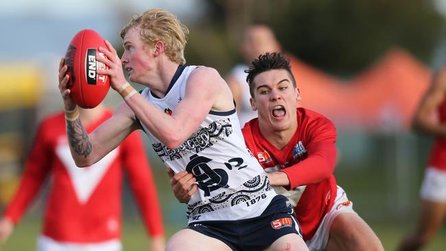 North Adelaide young talent Connor Rozee tackles South's Mark Noble at Noarlunga Oval on Saturday. Picture: AAP Image/Dean Martin