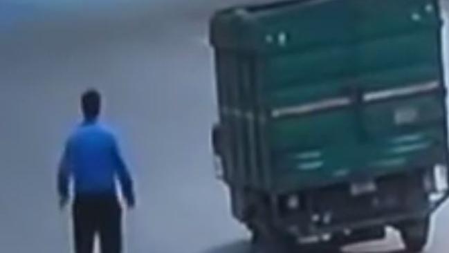 A stream of cars, motorcycles and pedestrians passed by an injured man struck by a delivery truck on a New Delhi street, leaving him to die. Picture: Youtube.