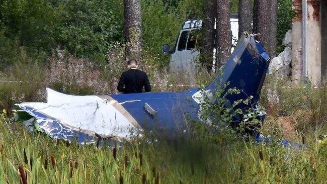 A law enforcement officer works at the site of a plane crash near the village of Kuzhenkino, which the Kremlin acknowledged could be ‘premeditated’. Picture: AFP