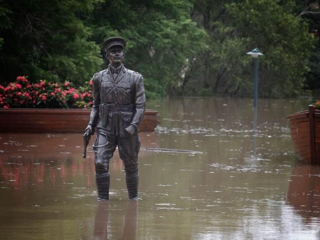 The statue of first man ashore at Gallipoli, Maryborough's Duncan Chapman, surrounded by water during the floods, much as he would have been on that tragic day in 1915.