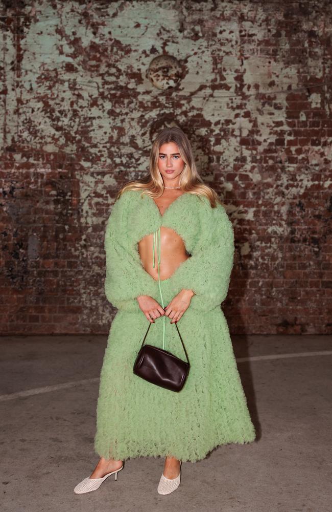 The lime green two piece flaunted her abs. Picture: Matrix