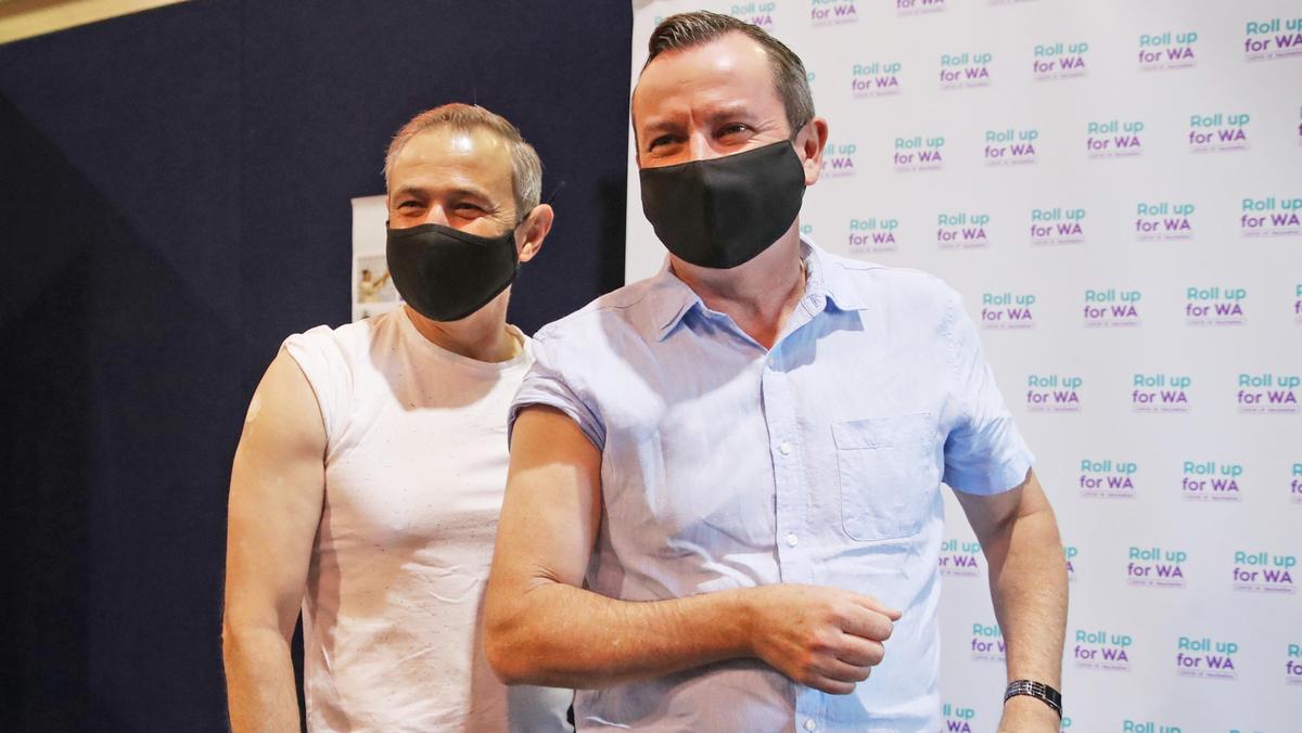 Health Minister Roger Cook and Premier Mark McGowan get their guns out after receiving their first dose of the AstraZeneca vaccine.