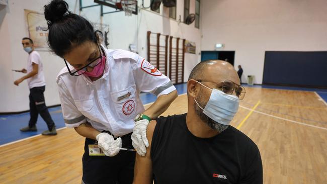 A paramedic with Israel's Magen David Adom medical service administers the third shot of the Pfizer-BioNTech Covid-19 vaccine on August 24, 2021 in Holon. Picture: AFP