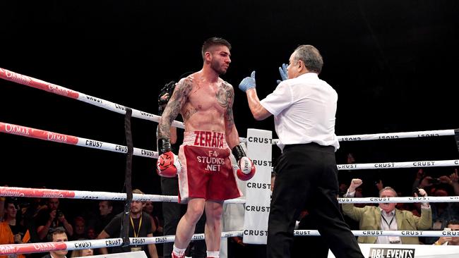 Michael Zerafa gets a standing count from referee John Cauchi. Picture: Getty