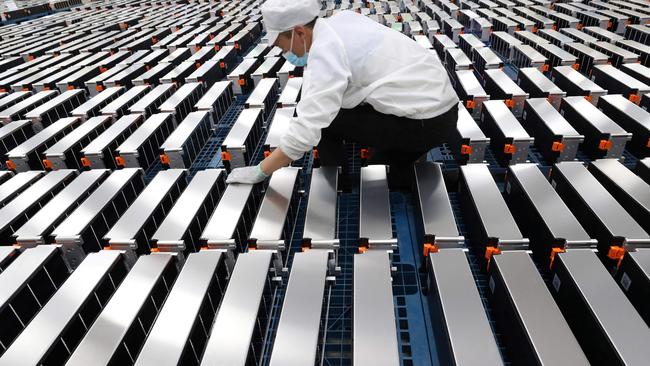 A worker with electric car batteries at one factory in China, indicating how much demand for the new-age vehicles has grown.