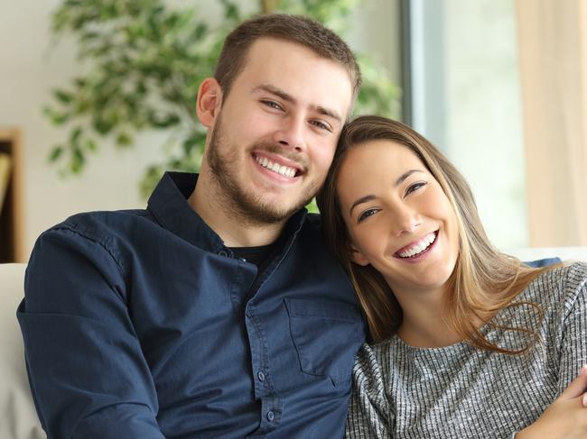 Generic photo -  Front view portrait of a happy couple posing and looking at camera sitting on a couch in the living room at home    Picture: iStock