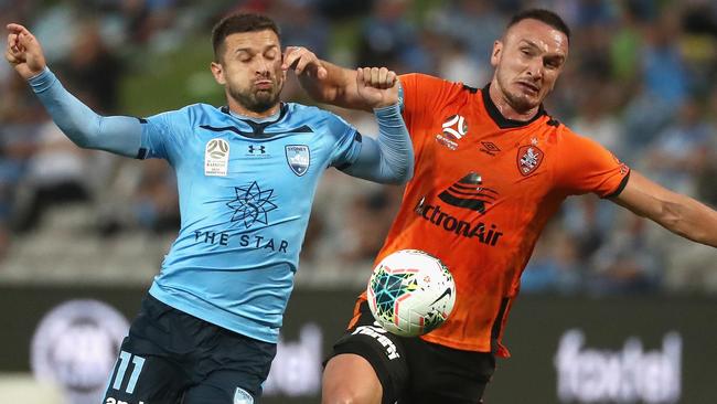 Kosta Barbarouses of Sydney FC and Captain of the Roar Tom Aldred challenge for the ball during the Round 9 A-League match between Sydney FC and Brisbane Roar at Netstrata Jubilee Stadium in Sydney, Saturday, December 7, 2019. (AAP Image/Jeremy Ng) NO ARCHIVING, EDITORIAL USE ONLY