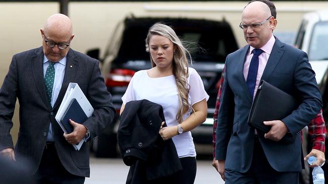 Amy Crisp (centre) arrives for the inquest into the Dreamworld disaster (AAP Image/David Clark) NO ARCHIVING