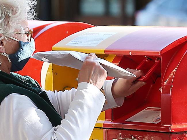 MELBOURNE, AUSTRALIA-NewsWire Photos OCTOBER 1, 2020 : Australia Post is hiring 4000 new employees ahead of what it says will be its "biggest Christmas ever". A lady posts a letter at Australia Post in Errol St. North Melbourne. Picture : NCA / NewsWire / Ian Currie