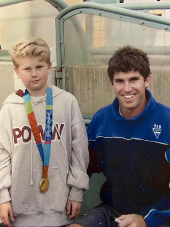 A young Josh Beltz, now a Kookaburras defender, with Olympian and former Kookaburras star Matthew Wells in 2004. Beltz is pictured wearing Wells' gold medal from the Athens Olympics that year. Picture: SUPPLIED