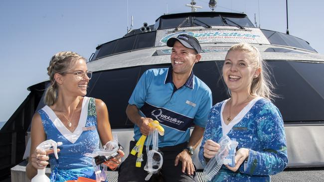 Quicksilver crew members Eliza White, Daniel Freiling and Phoebe Demarte prepare for the day hosting tourists on the Great Barrier Reef. The tourist spin off from the Olympics in Brisbane will have a major impact on tourism jobs, Quicksilver boss Tony Baker says. Picture: Brian Cassey