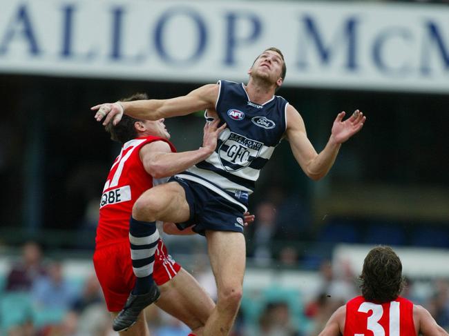 Paul Chambers leaps high against Sydney ruckman Jason Ball.