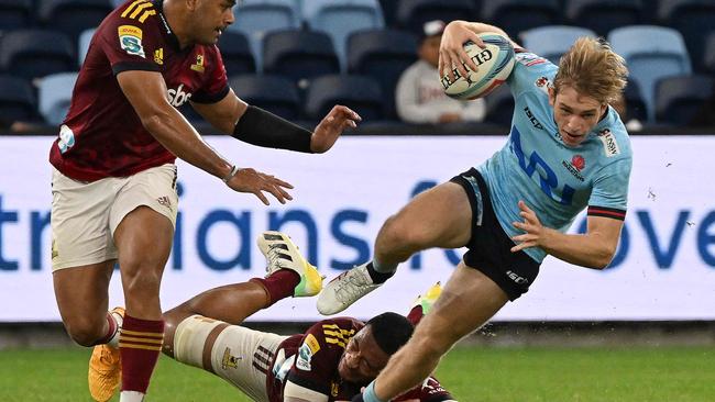 The Waratahs' Max Jorgensen tries to avoid a tackle. (Photo by SAEED KHAN / AFP)