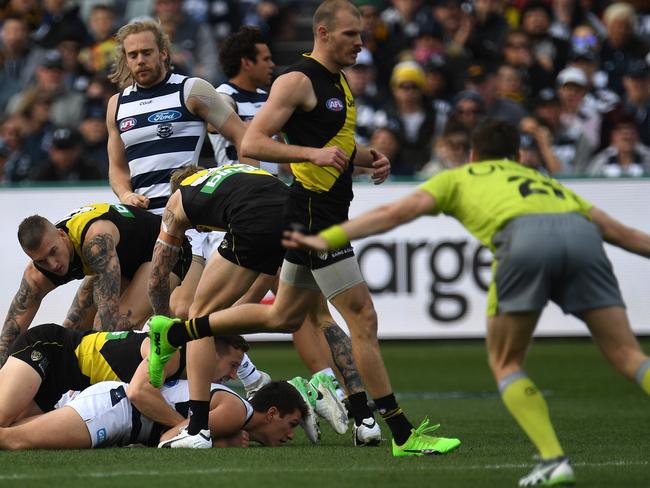Umpire Andrew Mitchell (right) awards a free kick for holding the ball during the Round 21 AFL match between the Geelong Cats and the Richmond Tigers at Simonds Stadium in Geelong, Saturday, August 12, 2017. (AAP Image/Julian Smith) NO ARCHIVING, EDITORIAL USE ONLY