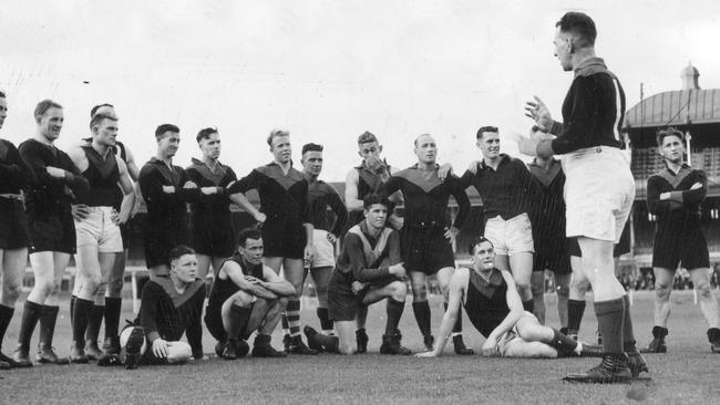 Checker Hughes addresses his troops on the MCG in 1937.