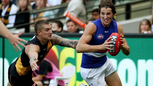 Dustin Martin and Marcus Bontempelli are squeezed onto the bench. Picture: Colleen Petch