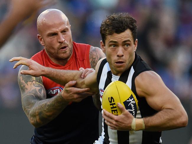 Nathan Jones of the Demons tackles Jarryd Blair of the Magpies (right) during the Round 12 AFL match between the Melbourne Demons and the Collingwood Magpies at the MCG in Melbourne, Monday, June 13, 2016. (AAP Image/Tracey Nearmy) NO ARCHIVING, EDITORIAL USE ONLY