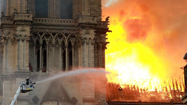 PARIS, FRANCE - APRIL 15: A firefighter is seen fighting the flames at Notre-Dame Cathedral April 15, 2019 in Paris, France. A fire broke out on Monday afternoon and quickly spread across the building, collapsing the spire. The cause is yet unknown but officials said it was possibly linked to ongoing renovation work. (Photo by Pierre Suu/Getty Images)