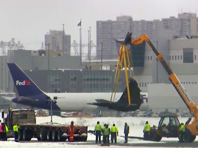 This image taken from video provided by CTV shows a crane lifting debris of a plane at Toronto Pearson Airport on Wednesday, Feb.19, 2025. (CTV via AP)