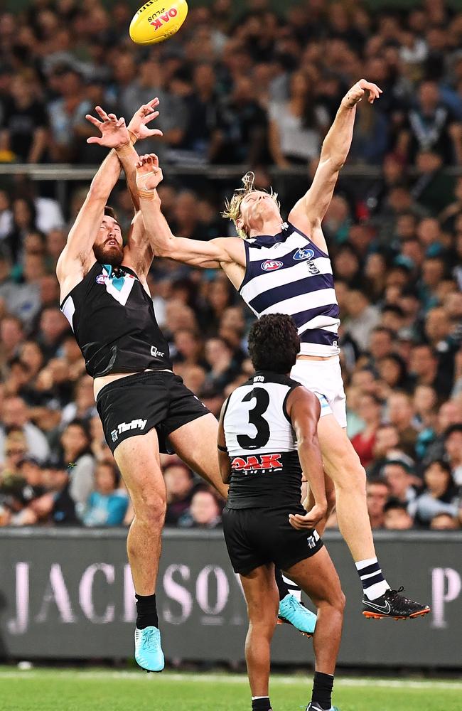 Charlie Dixon of Port Adelaide taps towards Jake Neade during the loss to Geelong.