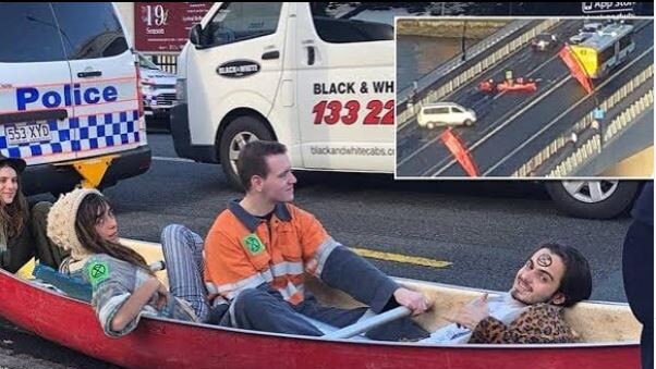 Eric Serge Herbert, right, in a canoe used in a protest that stopped traffic on the Victoria Bridge in Brisbane’s CBD - social media pics