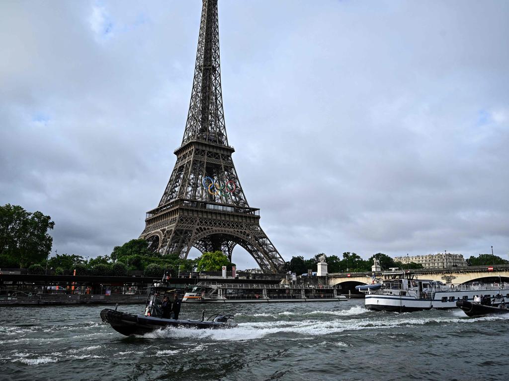 Police boats participate in a technical navigation rehearsal on the Seine river for the opening ceremony of the Paris 2024 Olympic Games. (Photo by JULIEN DE ROSA / AFP)