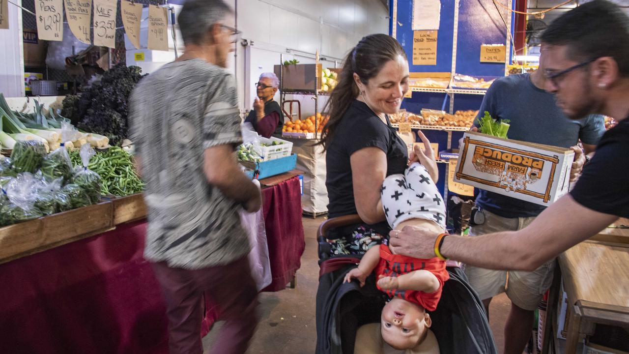 Cairns resident Erin Bell, with her 7-month-old son Tiago Fernandez, has been shopping in the iconic Rusty’s produce market, which has been open for business right through the coronavirus and lockdown. Picture: Brian Cassey