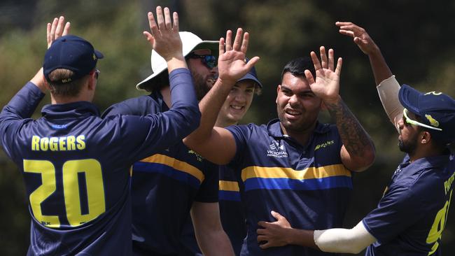 Darius D D'Silva and his Ringwood teammates celebrates the wicket of Daniel Satori. Photo: Hamish Blair