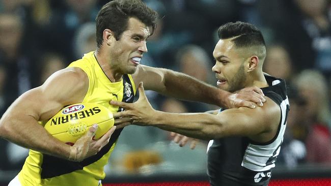 Jarman Impey attempts to tackle Richmond’s Alex Rance. Impey was one of the Port players guilty of missing kicks for goal he should have nailed. Picture: e Sarah Reed