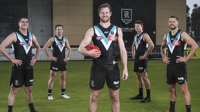 Port Adelaide captain Tom Jonas with teammates Tom Rockliff and Travis Boak with Jackson Mead and Mitchell Georgiades. Picture: Sarah Reed