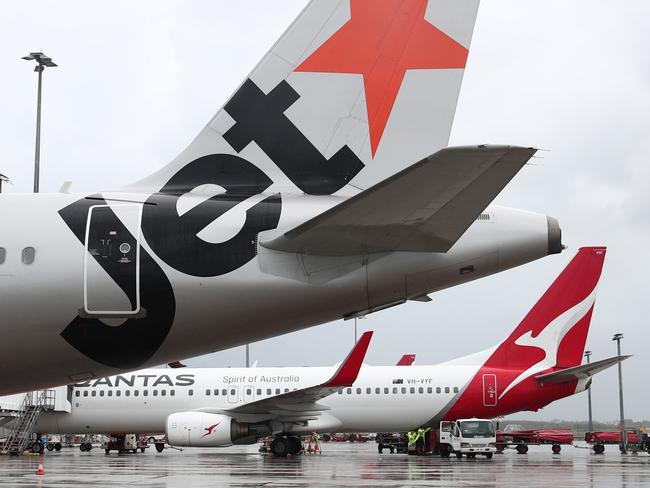 A Jetstar Airbus A320 and Qantas Boeing 737-800  jet aircraft at Cairns Airport after touchdown, bringing tourists and tourism dollars to Far North Queensland. Picture: Brendan Radkeescape december 6 2020 doc holiday