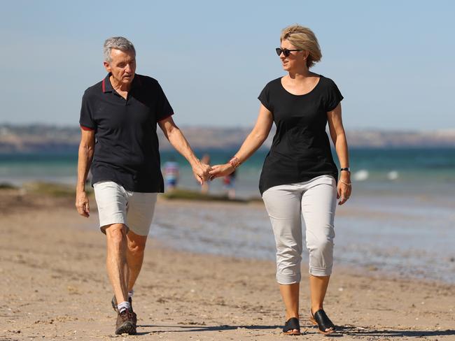 Bruce McAvaney and his wife Annie take a stroll along the beach near their home in Adelaide. Picture: Alex Coppel