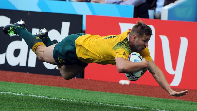 Drew Mitchell scores a try during Australia’s thumping win over Uruguay.