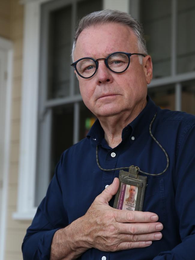 Joel Fitzgibbon holding Jack's identity badge,