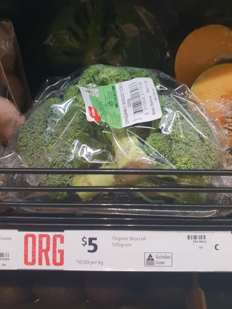 A few heads of broccoli were on display in a plastic bag.