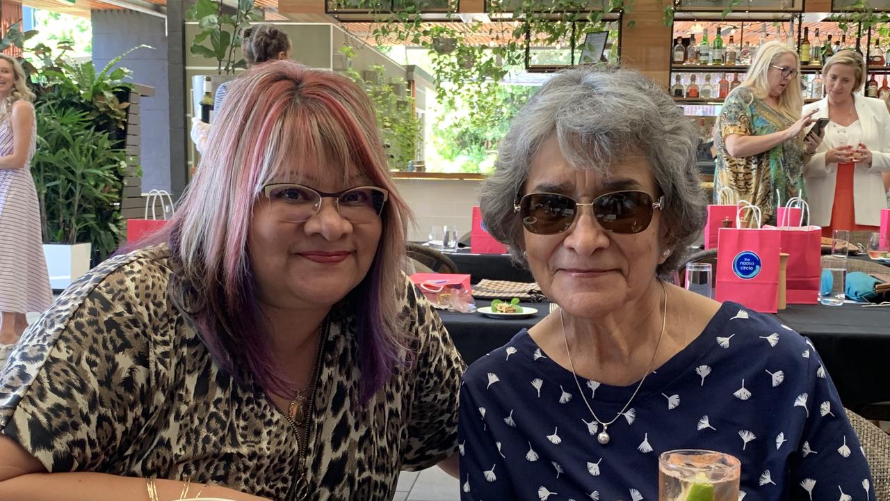 Taty Hindes and Maria Martinez share a drink and a chat at the Mayor's luncheon.