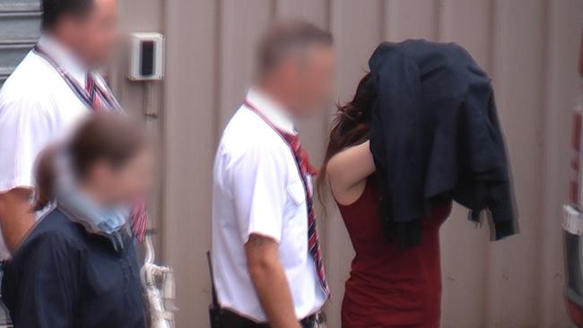 Andrea Chan Reyes is led out of court after her appearance at Adelaide Magistrates Court on Monday. Picture: Nine News