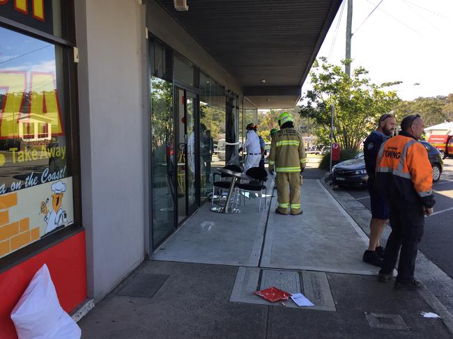 Fire and rescue crews inspect the damage. Picture: Richard Noone