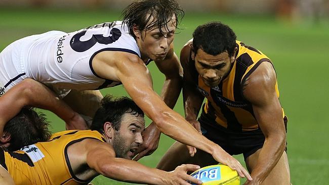 Jordon Lewis, Cyril Rioli and Cameron Sutcliffe compete for a ground ball. Picture Wayne Ludbey..