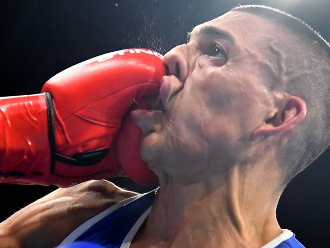 France's Sofiane Oumiha (L) lands a punch on Honduras' Teofimo Andres Lopez Rivera during the Men's Light (60kg) match at the Rio 2016 Olympic Games at the Riocentro - Pavilion 6 in Rio de Janeiro on August 7, 2016. / AFP PHOTO / Yuri CORTEZ
