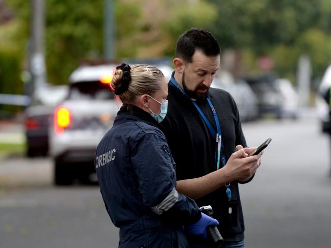 Investigators at the scene. Picture: Andrew Henshaw