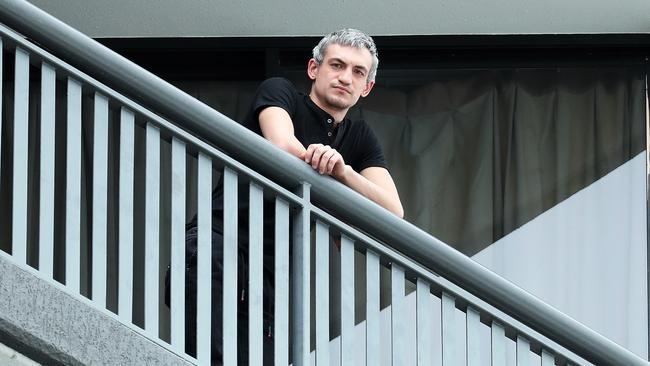 A quarantined man on his balcony at Brisbane’s Hotel Grand Chancellor, where new COVID-19 cases have been detected. Picture: Liam Kidston