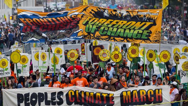 People gather near Columbus Circle before the People's Climate March in New York Sunday, Sept. 21, 2014. Thousands of people from across the nation are expected to participate in what's billed as the largest march ever on global warming. (AP Photo/Craig Ruttle)