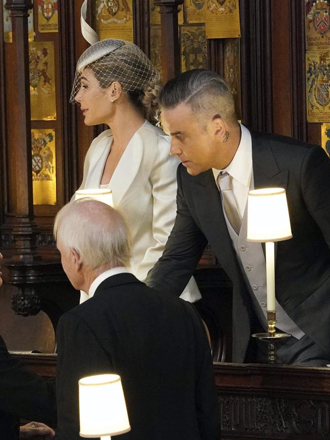 Robbie Williams and Ayda Field take their seats for the wedding. Picture: AP