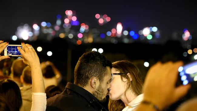 Felype Fixer, 28 and Jordyn Slater, 22, on Ruckers Hill Northcote, kiss at New Year's Eve in 2015. Picture: Jason Edwards.
