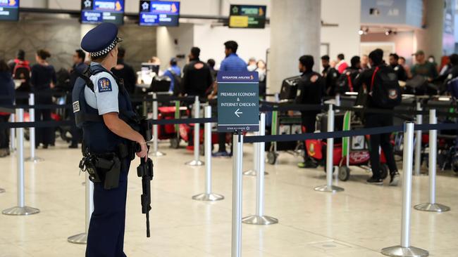 Armed police watch on as members of the Bangladesh cricket team check into Christchurch Airport. Picture: AFP