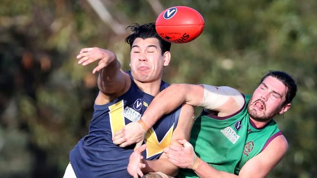 Whitefriars’ Marlon Simbolon vies with Old Paradians’ Jake Plunkett for possession on Saturday.