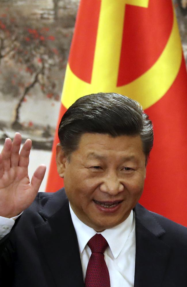 Chinese President Xi Jinping waves while addressing the media as he introduced new members of the Politburo Standing Committee at Beijing's Great Hall of the People. Picture: AP